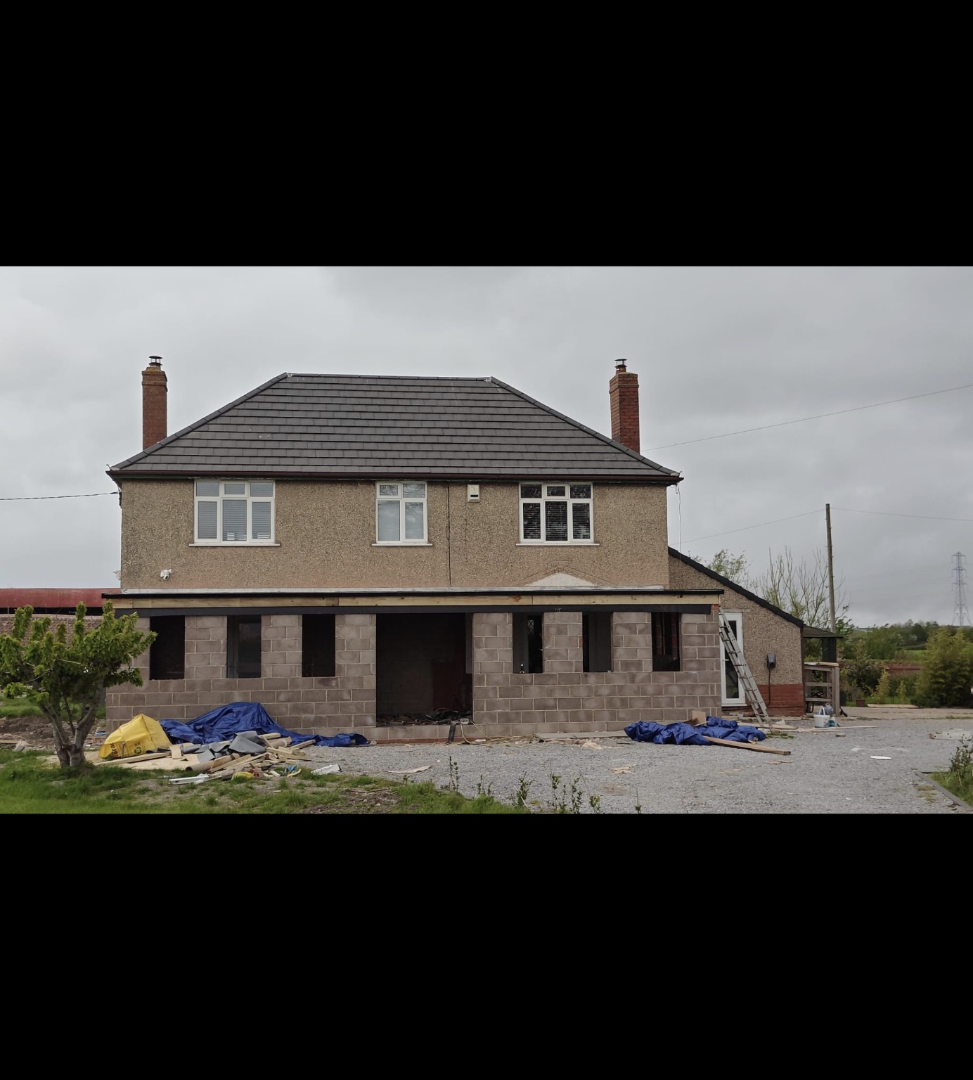 Front view of the grey pitched roof and brick chimneys in Bridgwater