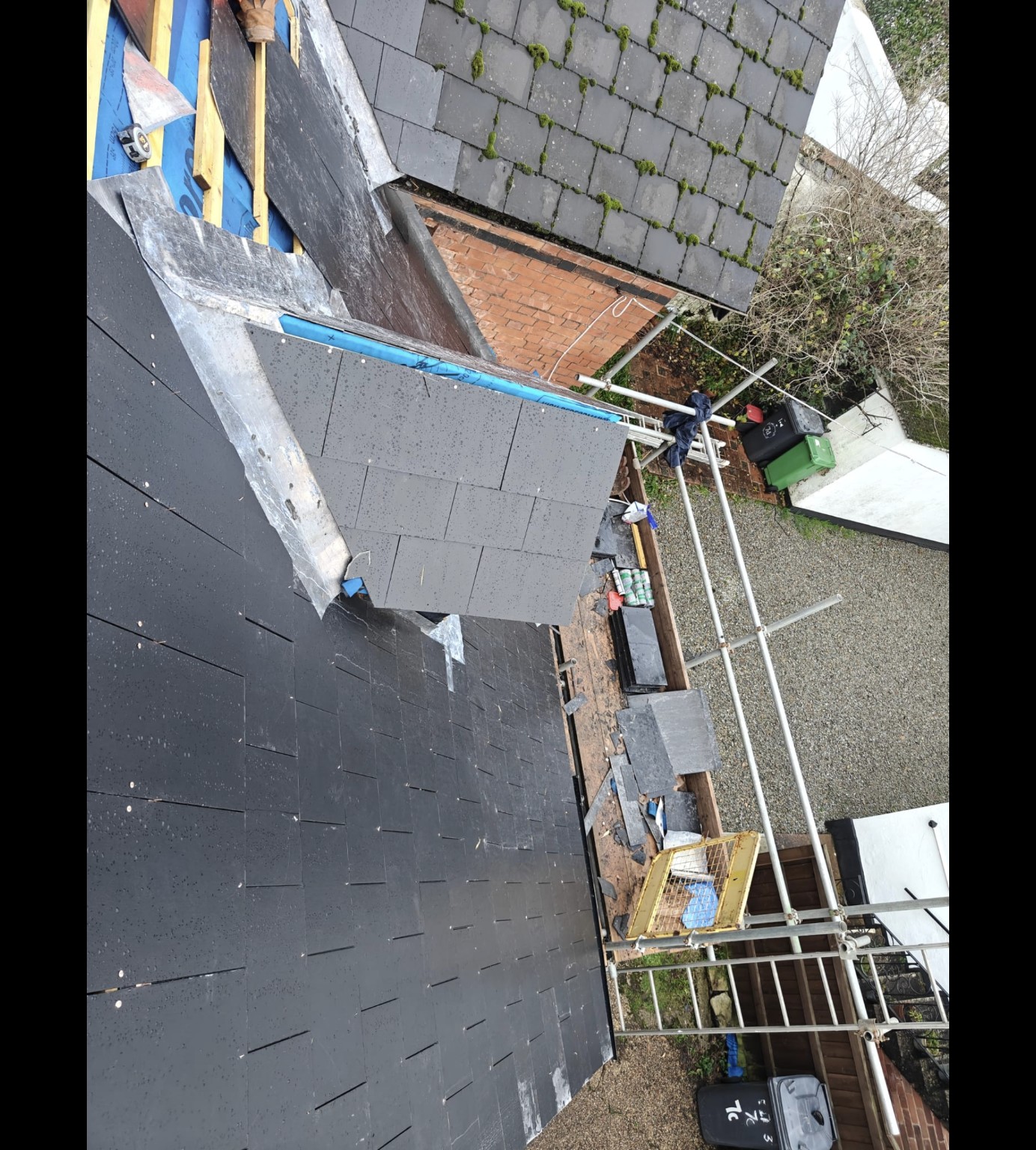 Close-up of slate roofing and lead flashing during installation