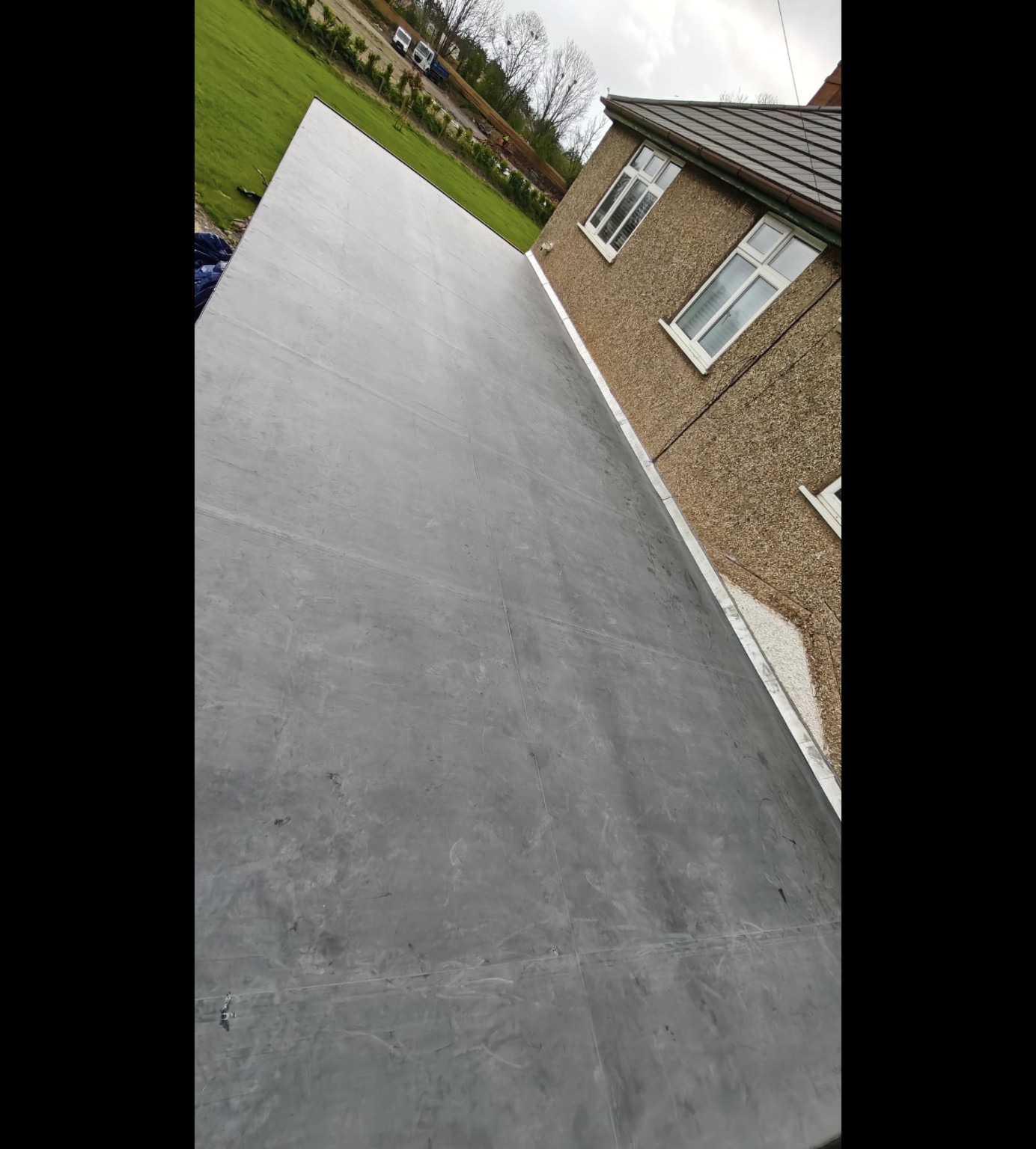 Rubber flat roof with wall flashing on an Ominiworks roofing project in Exeter