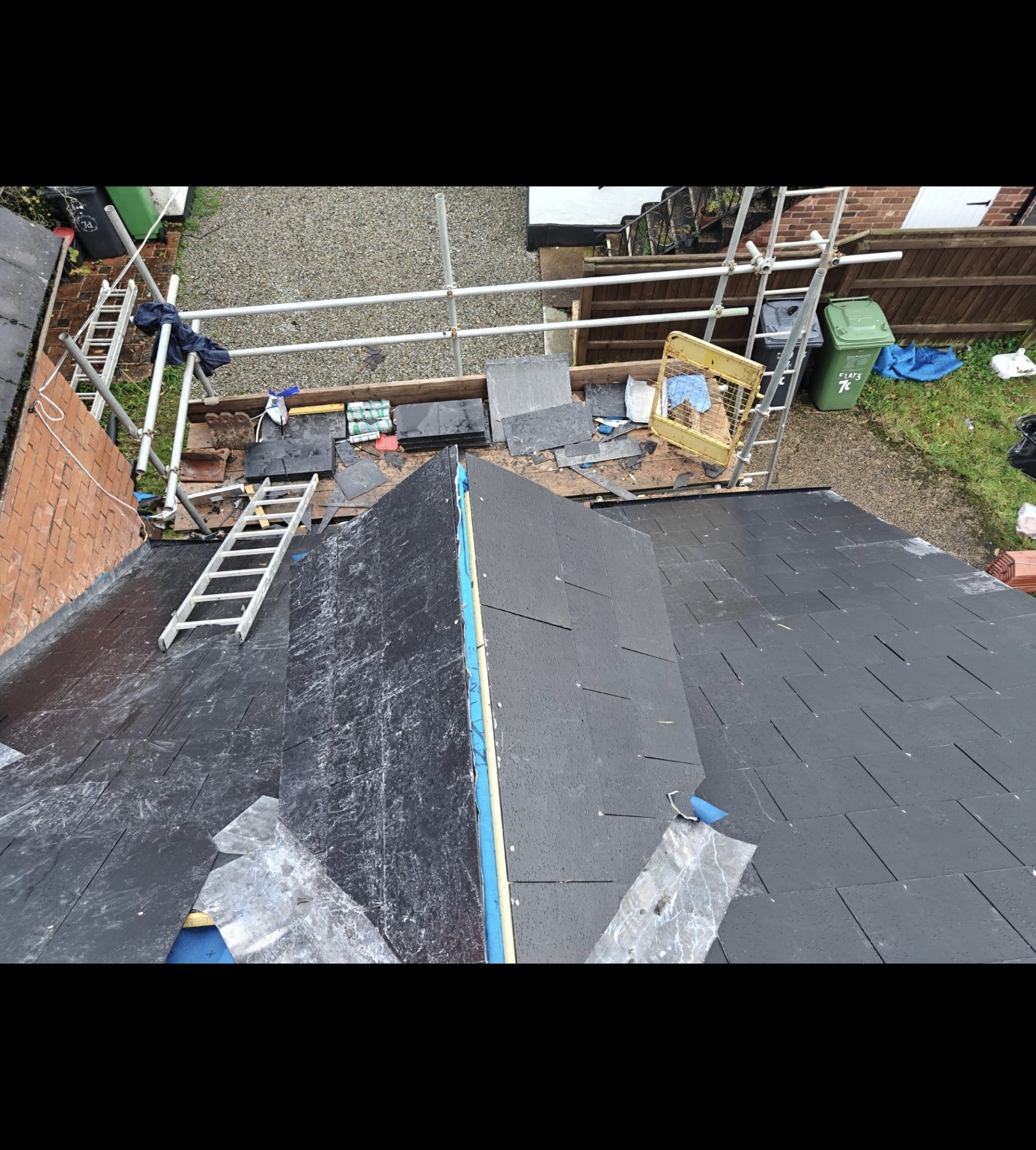Slate roof installation with leadwork at a roof junction